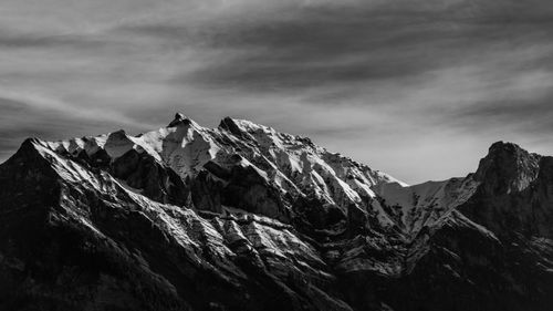 Scenic view of mountains against cloudy sky