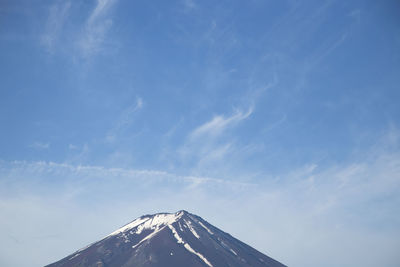 Low angle view of snowcapped mountain against sky