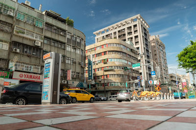 City street by buildings against sky