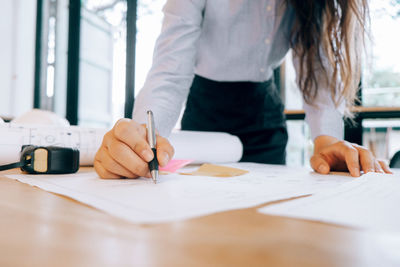 Midsection of woman working on table