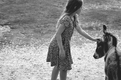 Rear view of woman standing on field