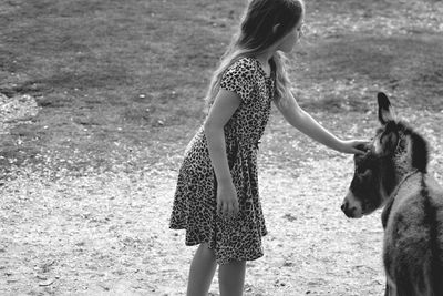 Rear view of woman standing on field