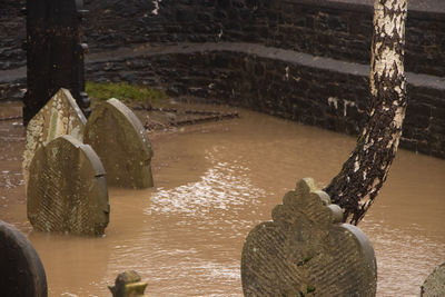 High angle view of wooden posts in sea