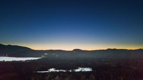 Scenic view of mountains against clear blue sky