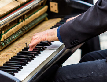 Cropped image of man playing piano