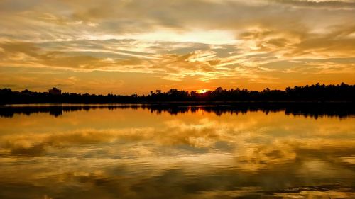 Scenic view of lake against romantic sky at sunset