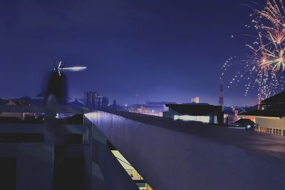 Blurred motion of woman on building terrace at night