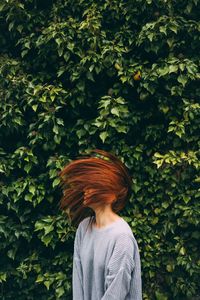 Rear view of two leaves against trees