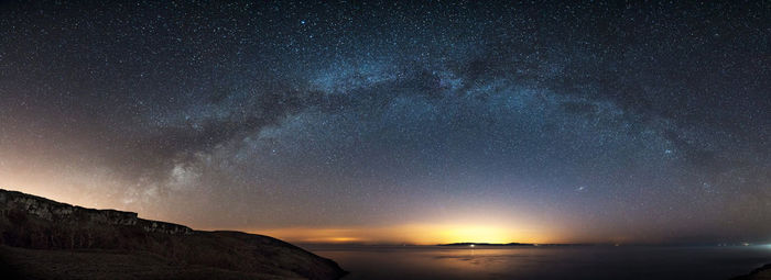 Scenic view of sea against sky at night