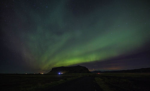 Scenic view of landscape against sky at night