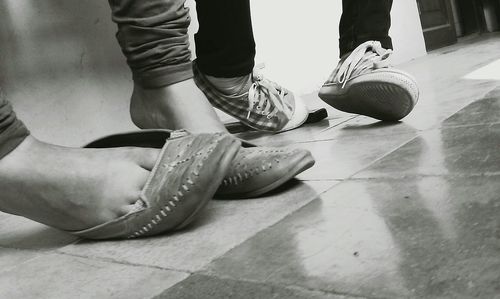 Low section of woman standing on tiled floor