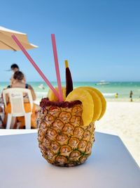 Pinneapple cocktail by the beach in mexico 