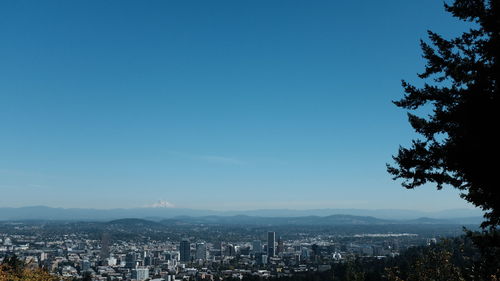 Cityscape against clear blue sky