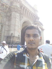 Portrait of young man against built structure