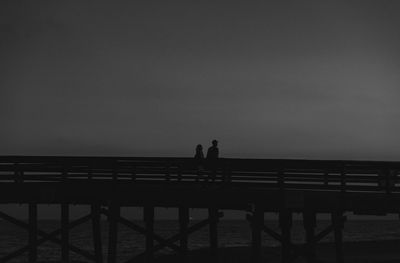 Silhouette of people against sky