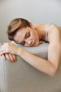 Portrait of young woman lying on floor at home