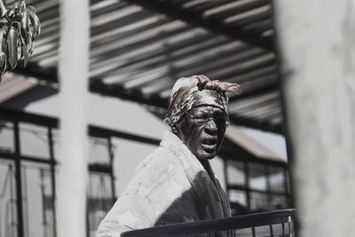 Low angle view of statue against historic building