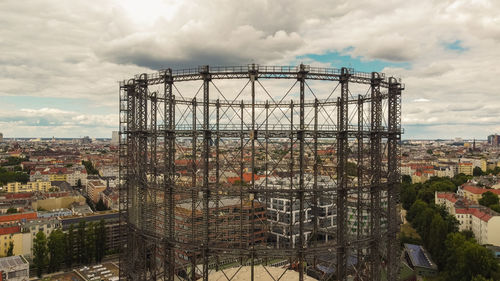 Construction site by buildings against sky