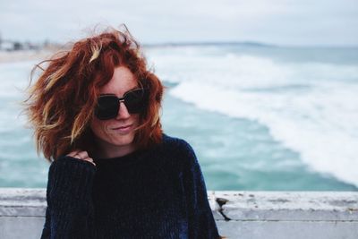 Close-up portrait of woman standing at beach