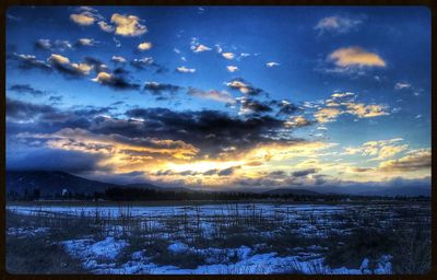 Scenic view of frozen lake against sky during winter