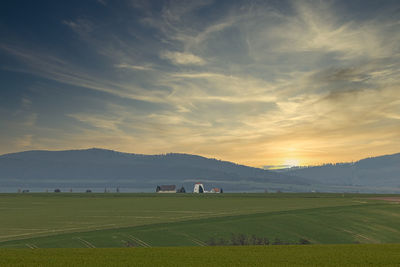 Scenic view of field against sky during sunset