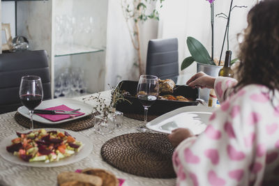 Midsection of woman sitting on table