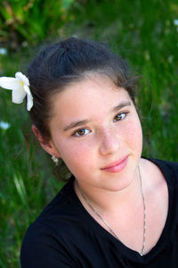 Portrait of teenager with flower in hair