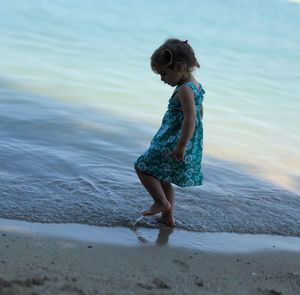 Full length of woman standing on beach