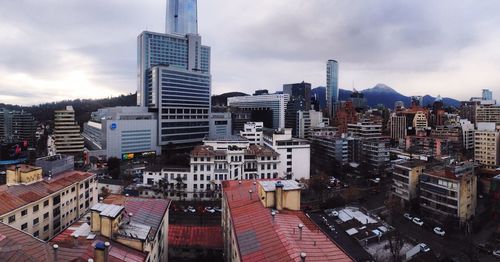 Cityscape against cloudy sky