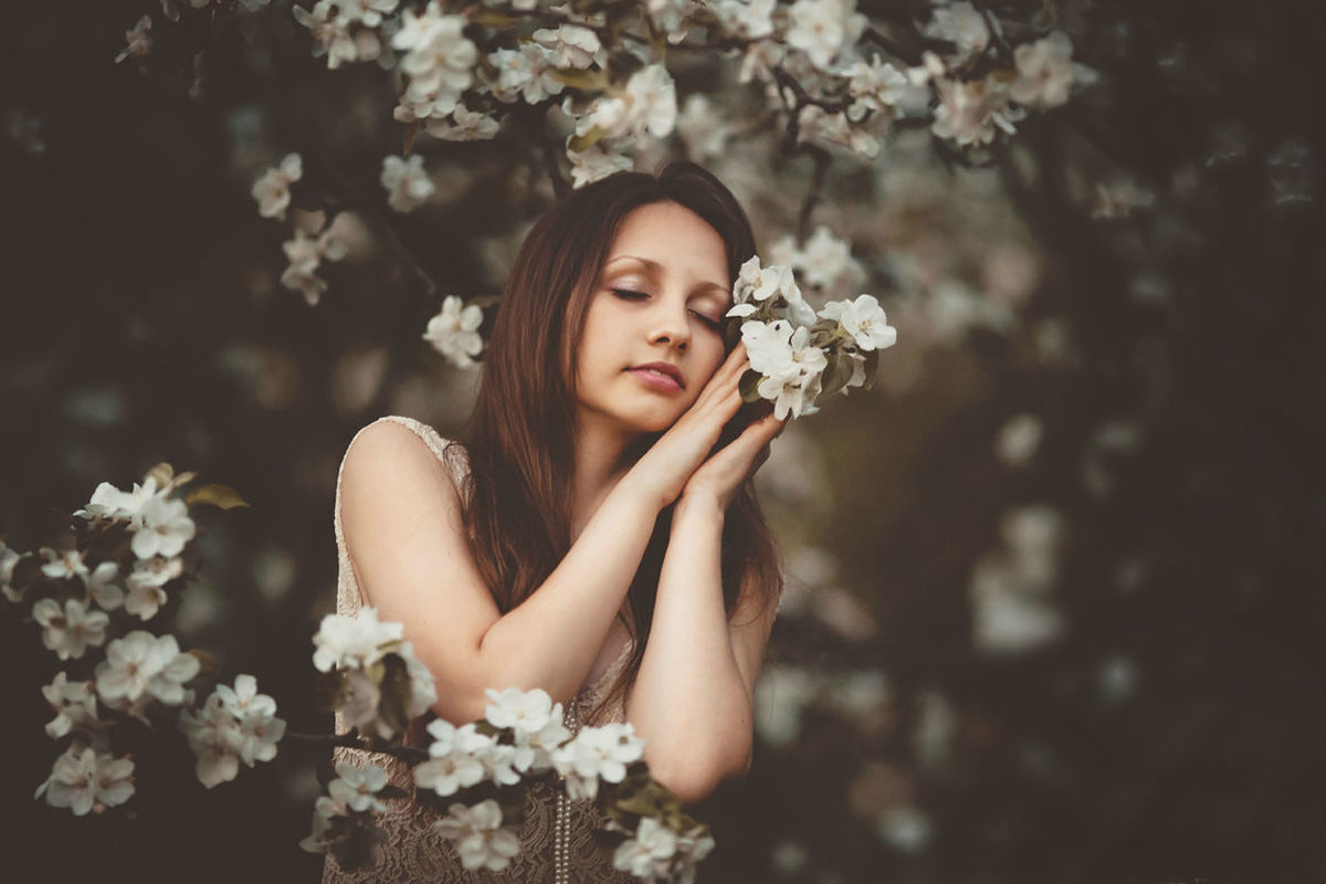 YOUNG WOMAN HOLDING FLOWERS