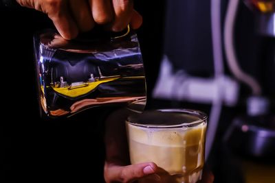 Midsection of person holding drink