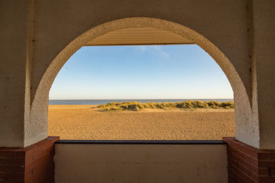 Scenic view of sea against clear sky seen through window