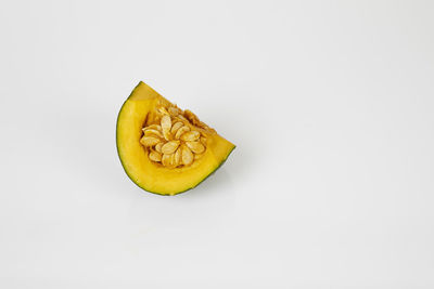 Close-up of lemon slice against white background