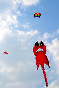 Low angle view of kite flying hanging against sky