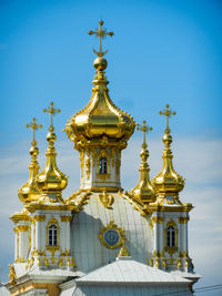 Low angle view of statue of building against blue sky