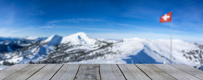 Scenic view of snowcapped mountains against blue sky