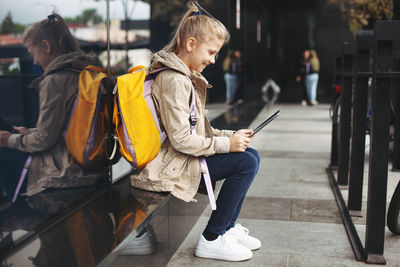 Girl using tablet in city