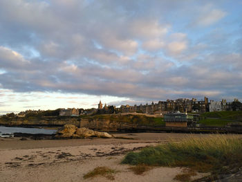 Scenic view of beach against sky in city