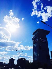 Low angle view of buildings against cloudy sky