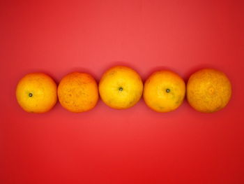 Close-up of fruits against orange background