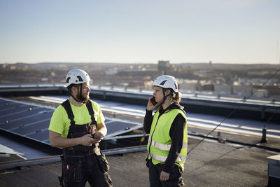 Workers standing on roof