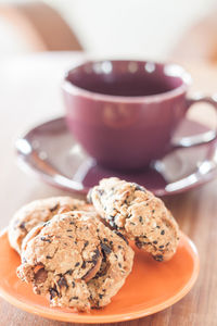 Close-up of cookies and coffee cup on table