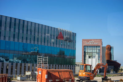 View of modern buildings against clear blue sky