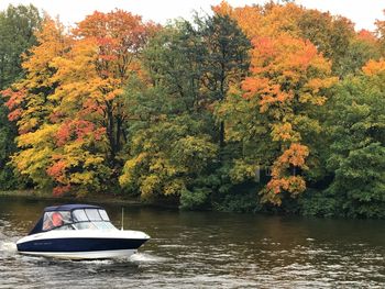 Boat in lake by trees during autumn