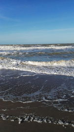 Scenic view of sea against blue sky