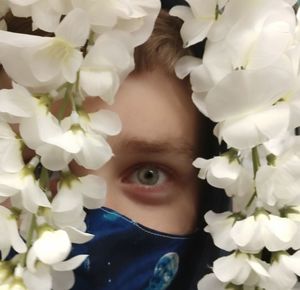 Close-up portrait of woman with pink flowers