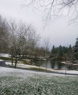 Scenic view of lake against sky during winter