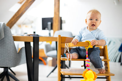 Portrait of boy playing with toy car