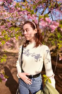 Woman standing by flowering plants