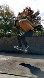 Low section of man skateboarding on skateboard